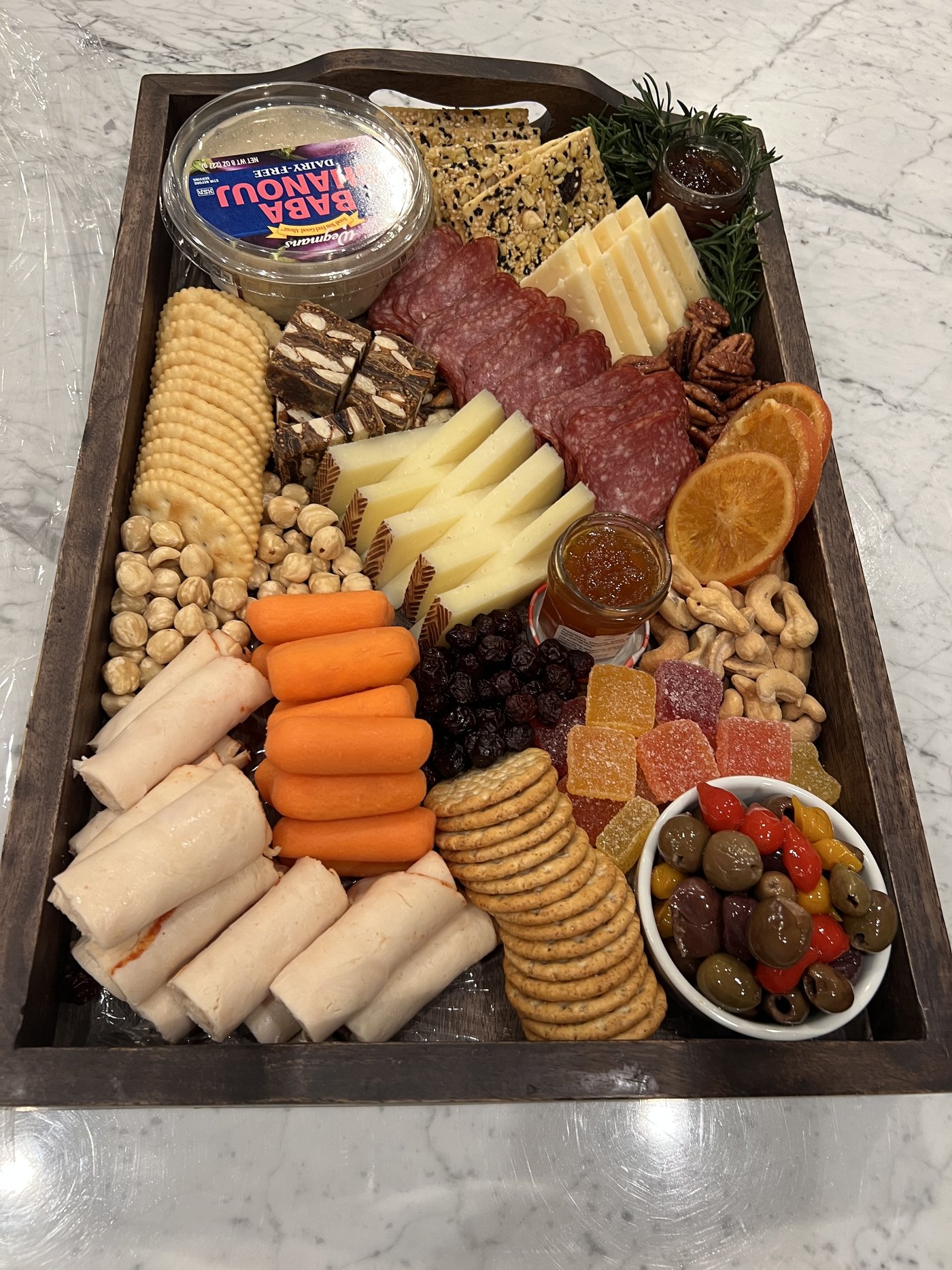 The Garden — overhead view with brie, salami, fresh produce, and condiments